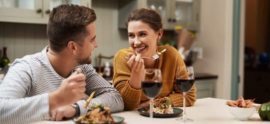 Smile,,Couple,And,Eating,Food,In,Home,With,Wine,On